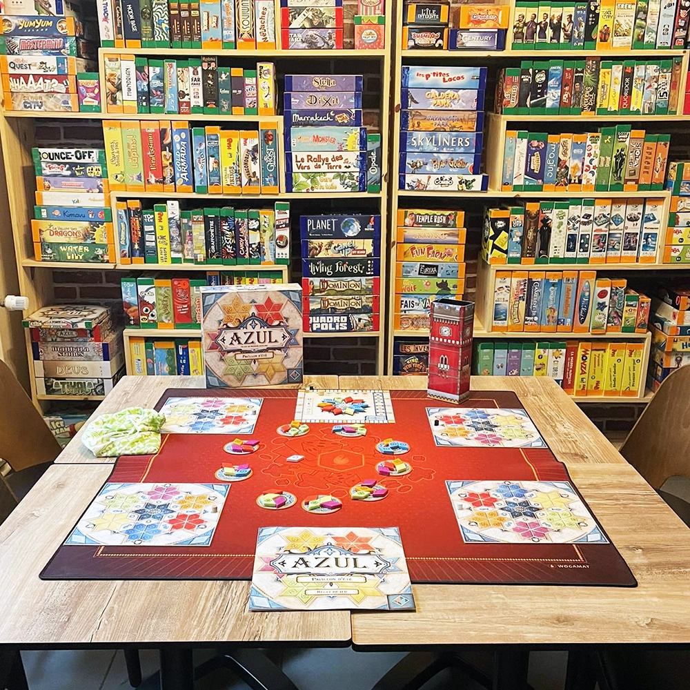 Table jeu prêt à jouer et une étagère remplie de jeux de société pour la location jeux de société